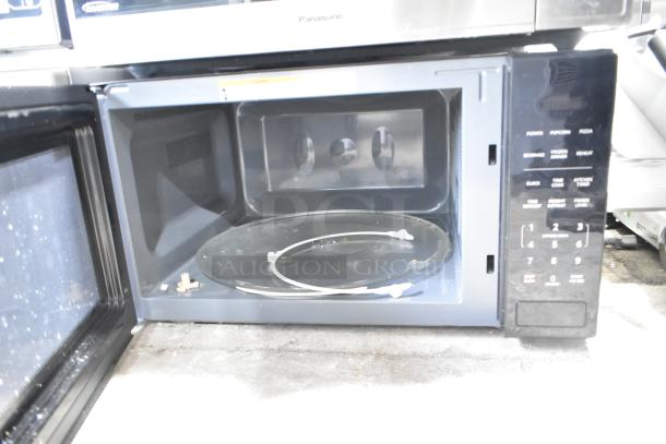 Mainstays MS8436193153-01 countertop microwave oven with plate shown open. Features control panel, uses 120 volts, 1 phase.