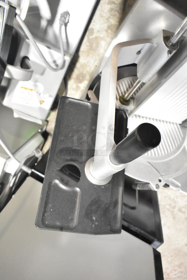 Bizerba GSP H commercial meat slicer, 120 volts, 1 phase, good condition, features ergonomic handle, safety guard.