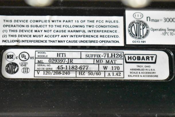 2017 Hobart HTi-7LH26 commercial scale label showing model, serial number, voltage, and compliance details.