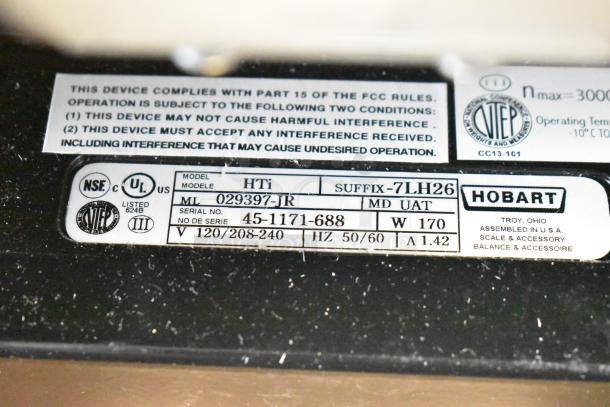 2017 Hobart HTi-7LH26 commercial countertop scale label, showing model and serial numbers, voltage, and compliance info.
