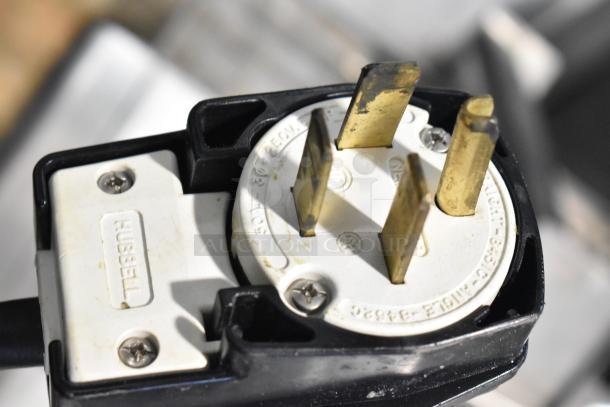 Plug for Fri-jado TDR7-P rotisserie oven, Hubbell label. For 208V, 3-phase power. Part of commercial cooking equipment.