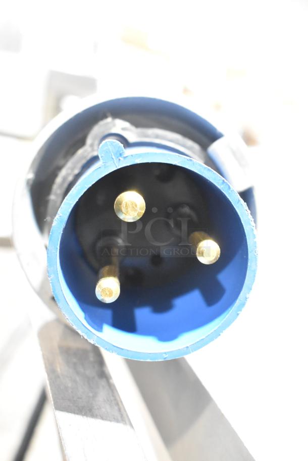 Close-up of a blue electrical connector from the Belshaw Adamatic TG-50 Thermoglazing Station. Visible prongs inside.