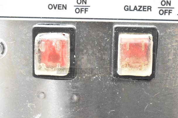 Belshaw Adamatic TG-50 stainless steel thermoglazing station control panel showing oven and glazer switches.
