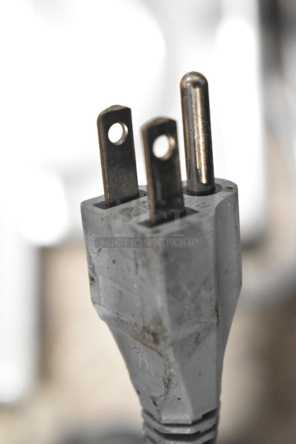 Close-up of a power plug for the 2020 Bizerba GSP H commercial meat slicer, showing a three-prong plug.
