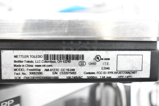 Mettler Toledo FreshWay AM-6127C scale label showing model, serial number, voltage, and certifications.