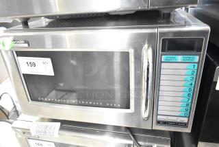 Sharp R-21LVF Commercial Microwave Oven, 2022 model, stainless steel, 120 volts, 1 phase. Control panel and labels visible.