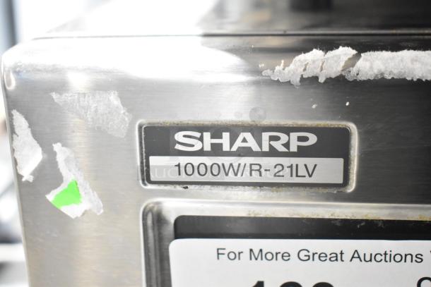 2022 Sharp R-21LVF commercial microwave, 1000W, stainless steel, visible wear. Label: "Sharp 1000W/R-21LV".