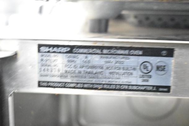 Sharp R-21LVF Commercial Microwave Oven label showing model details, 120 volts, 1 phase, manufactured in 2022.