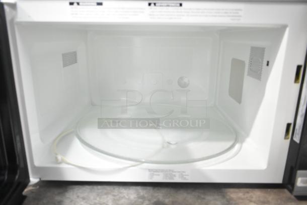 2020 Panasonic NN-SN975S microwave interior with glass plate, 120 Volts, 1 Phase, clean condition, model visible.