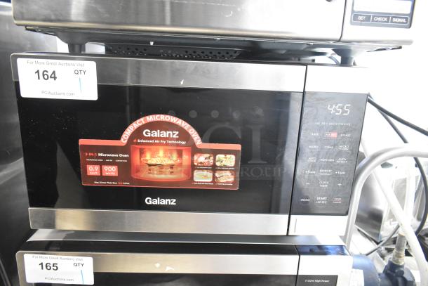 Galanz 667126859 countertop microwave, used as display, no power cord. Features 3-in-1 functionality, 900W, 0.9 cu. ft.