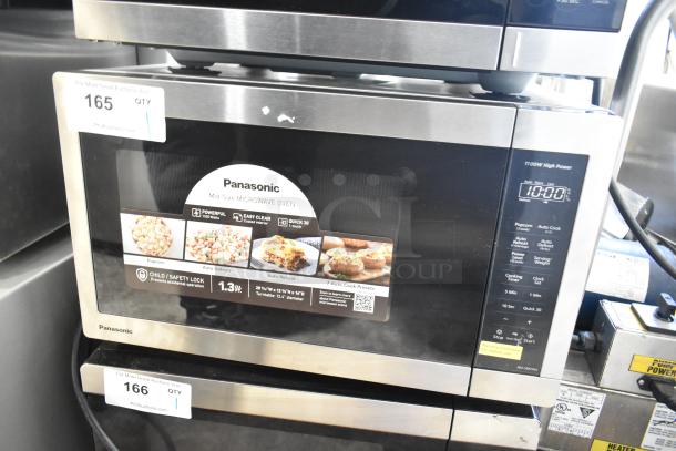 Panasonic countertop microwave oven, 1100W, used as display, missing power cord, 120V, 1 phase. Features auto defrost and reheat.