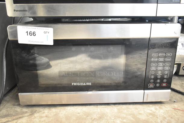 Frigidaire EMW1120 countertop microwave oven, used as display, missing power cord. 120 volts, 1 phase. Control panel visible.