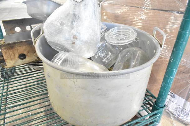 Auction tier lot with metal pot, glass jars, and assorted items. Includes kitchenware like skillets and bowls. Various conditions.