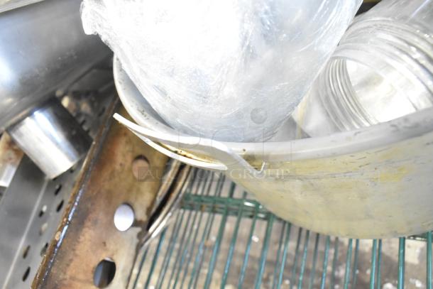 Tier lot with skillets, bowls, coffee pot, and metal pot. Items in mixed condition; visible wear on metal surfaces.