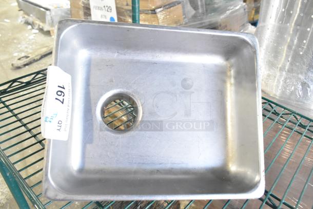 Metal kitchen sink with drainage hole, lot tag 167 visible. Part of a tiered auction lot including skillets, bowls, coffee pot, metal pot.