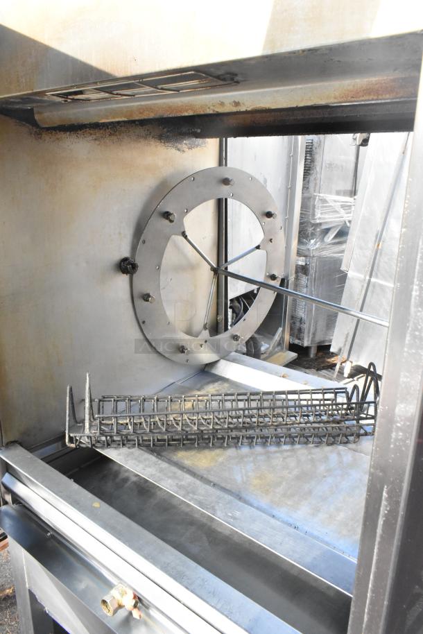 Fri-jado TDR7-P commercial rotisserie oven interior, showing cooking chamber and rotisserie rod, on industrial casters.