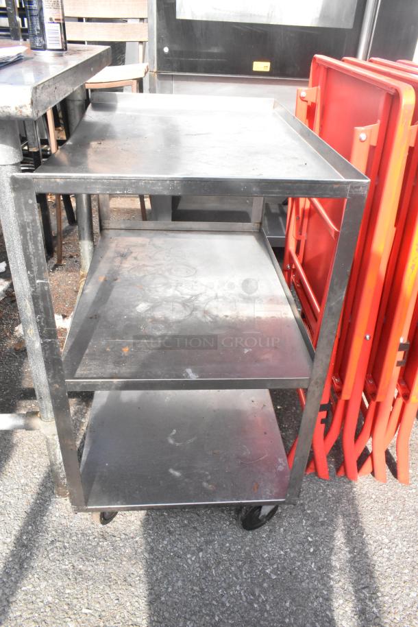 3-tier metal cart with commercial casters, used condition, visible wear on shelves. Ideal for industrial or storage use.