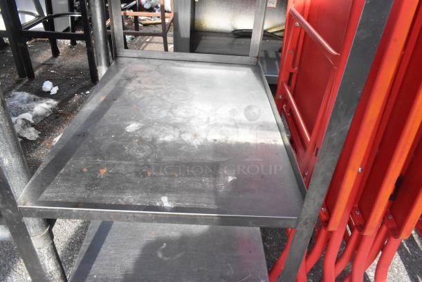 3 tier metal cart with commercial casters, showing wear and surface rust. Ideal for industrial use.