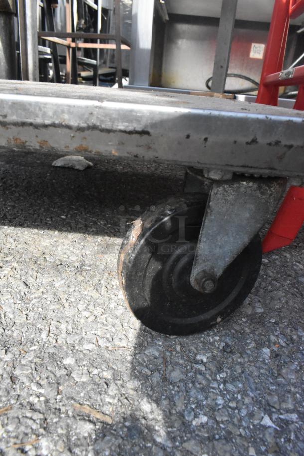 3 tier cart with commercial casters, minor surface rust on metal frame, suitable for industrial use.