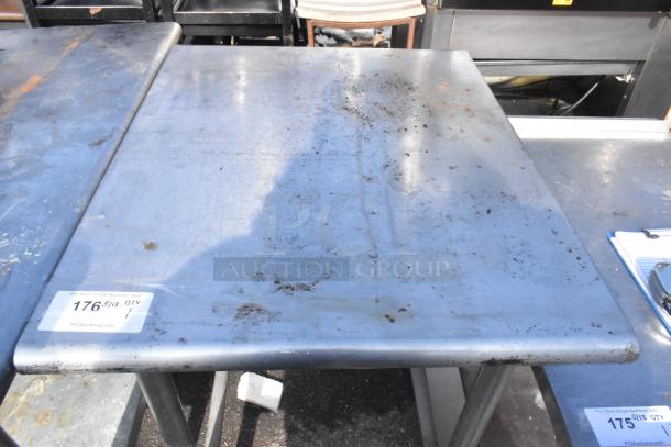 Commercial table with metal surface, visible wear and rust marks. Auction tag number 176 indicates PCI Auctions.