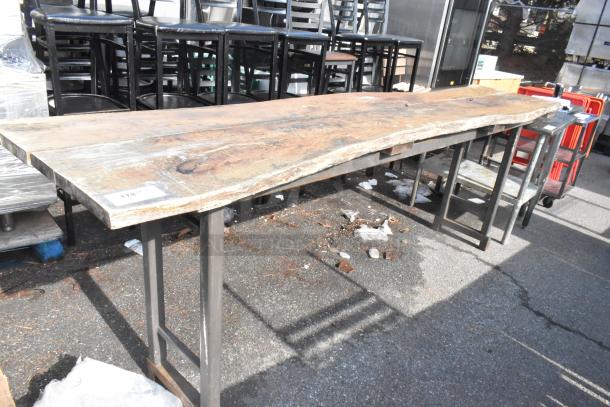 Commercial butcher block table with metal legs, weathered wood surface, slight wear. Tag marked "178".