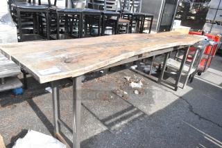Commercial butcher block table with metal legs, weathered wood surface, slight wear. Tag marked "178".