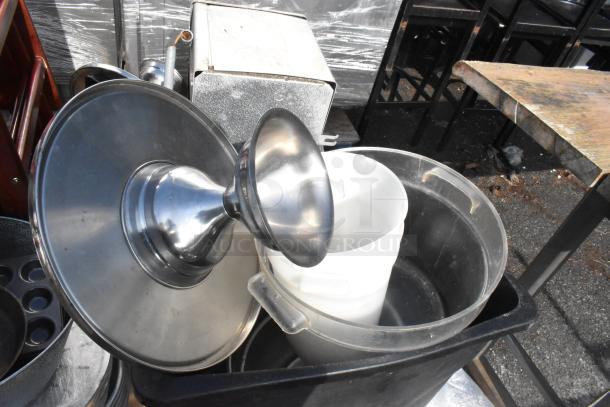 Pallet of mixed items including a stainless evaporator, high chairs, trash can, and skillets. Items appear used.