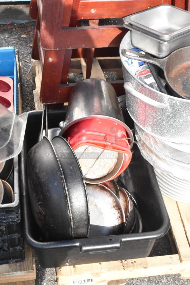 Pallet lot with metal skillet, high chairs, stainless steel containers on a wooden pallet, mixed condition.