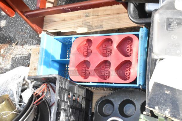 Pallet with assorted items including a red heart-shaped silicone baking mold and various skillets in fair condition.