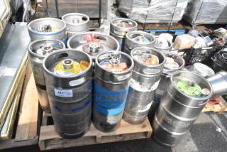 Twelve assorted beer kegs on pallets, various brands and labels visible, in used condition, auction item.