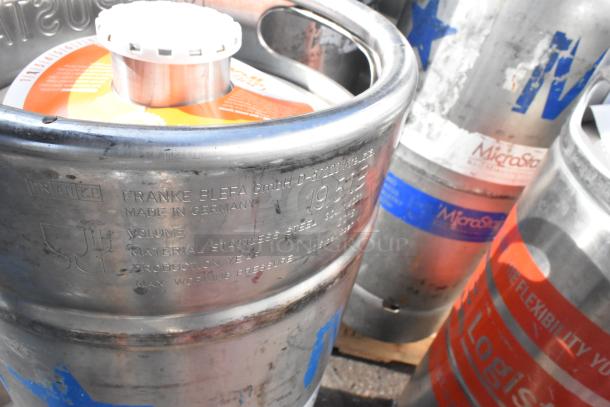 Twelve stainless steel kegs, including Franke Blefa brand, showing markings of manufacturing details and usage.