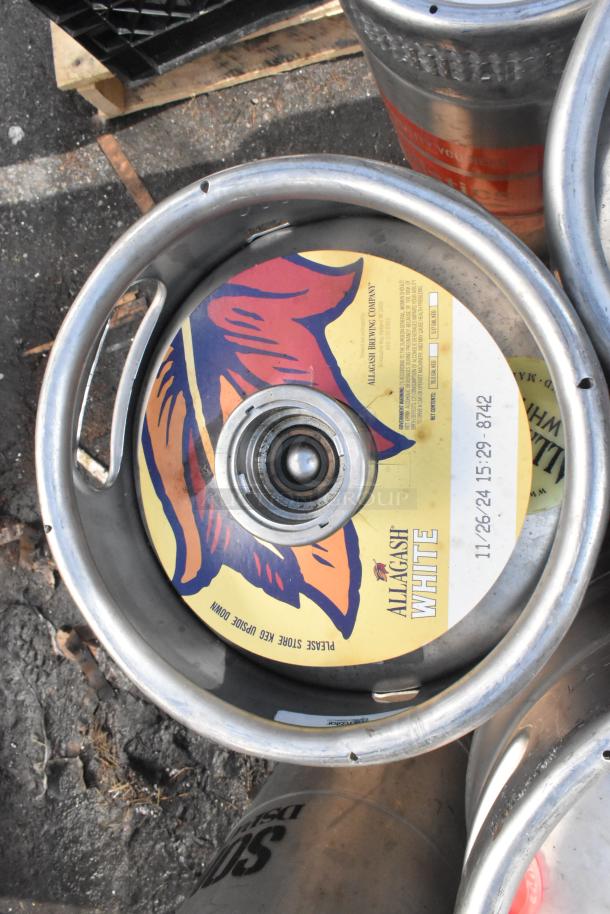 12 metal kegs with "Allagash White" label. Visible date 11-26-24. Good condition. Auction for 12 kegs.