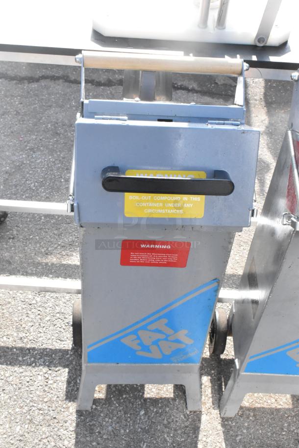 2 Commercial Fat Vat oil shuttles with wheels and handles. Visible warning labels emphasize safety. Used condition.