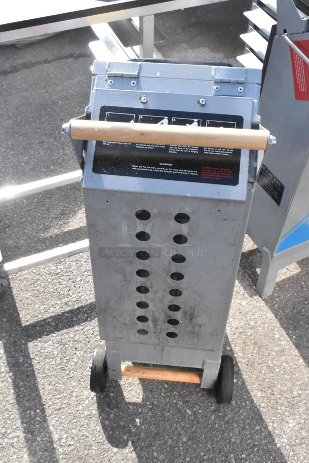 Commercial Fat Vat Oil Shuttle with wheels and wooden handle; metal body, instructions on top, slightly worn condition.