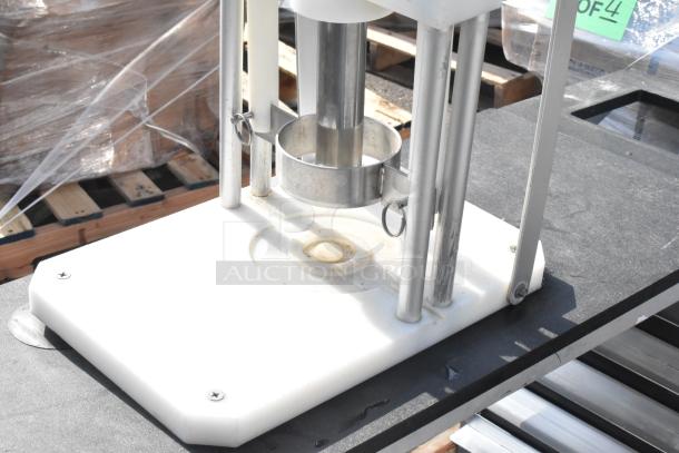 Countertop Pineapple Corer with stainless steel blade, plastic base, and handles. Appears in used condition, no visible labels.