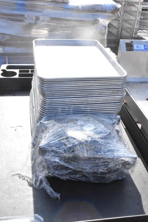 Poly 2 Tier Cart on commercial casters with stacked baking trays and wrapped contents. Used condition.