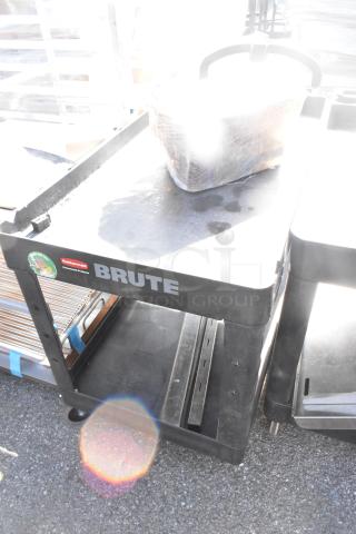 Rubbermaid Brute Poly 2 Tier Cart with contents, on commercial casters, black, good condition, visible Brute label.