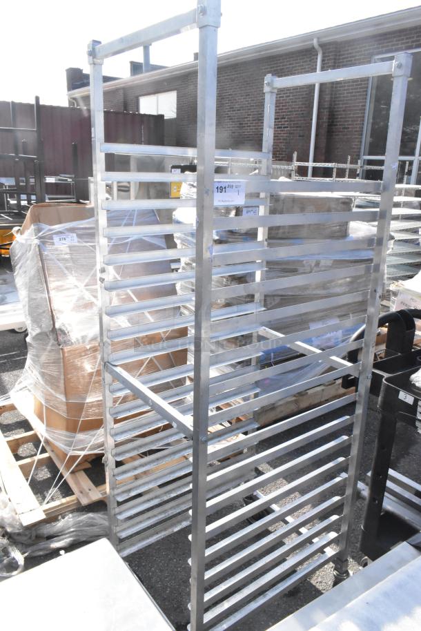 Commercial pan transport rack on casters, features multiple shelves for pan storage, durable metal construction.