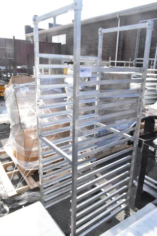 Commercial pan transport rack on casters, features multiple shelves for pan storage, durable metal construction.