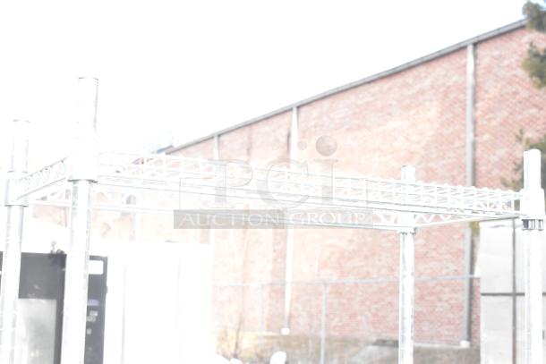 Metal table with two-tier wire over shelf, industrial-style, sturdy condition, suitable for storage or display.