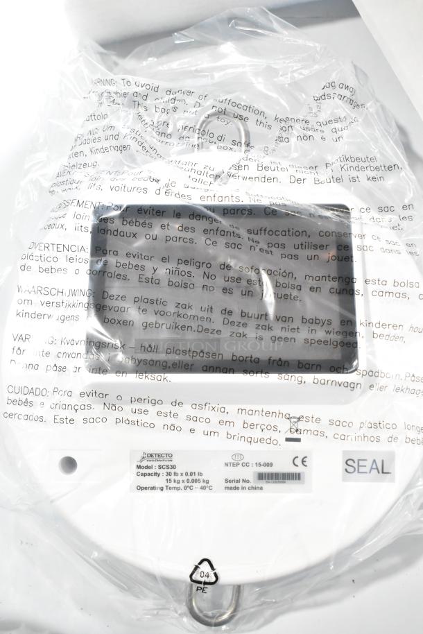 Detecto SCS30 digital solar hanging scale in packaging, featuring 30 lb capacity, model SC30, made in China. New condition.