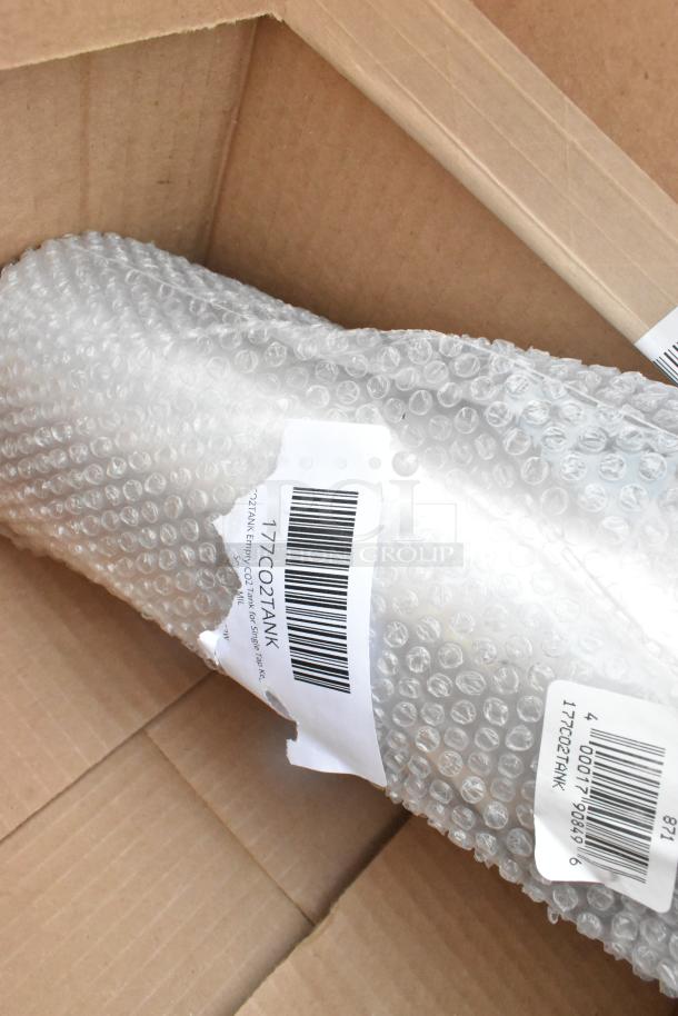 Bubble-wrapped CO2 tank in open cardboard box, labeled "177CO2TANK" for auction, scratch and dent condition.