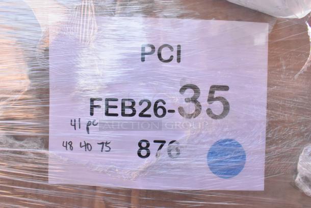 Box labeled "PCI FEB26-35" wrapped in plastic, containing 42 brand new scratch and dent items including paper products.