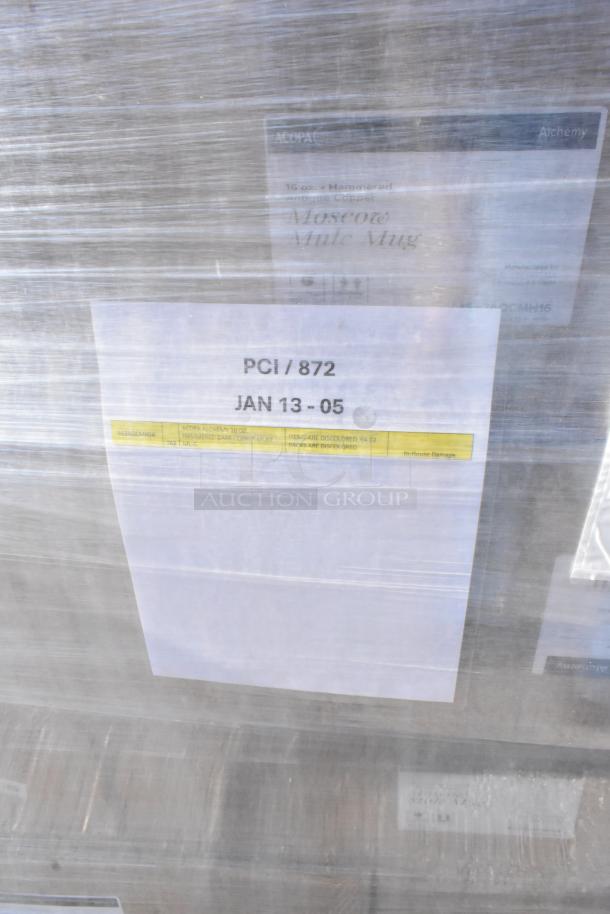 Pallet of assorted items, including Acopa hammered mule mugs. Labeled "PCI/872 JAN 13-05," with some discoloration noted.
