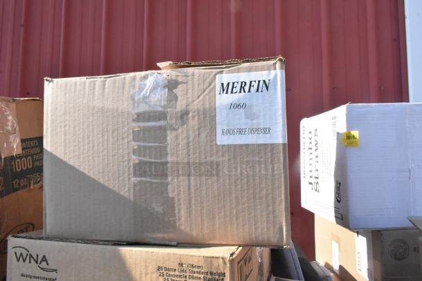 Cardboard boxes stacked outdoors, one labeled "MERFIN 1060 Hands Free Dispenser." Contains 25 assorted new scratch and dent items.