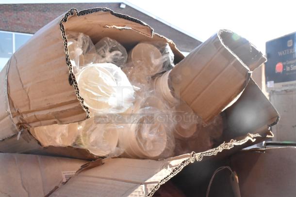 Damaged box of new, wrapped hot cups and bandage wraps, showcasing mixed items in scratch and dent condition.