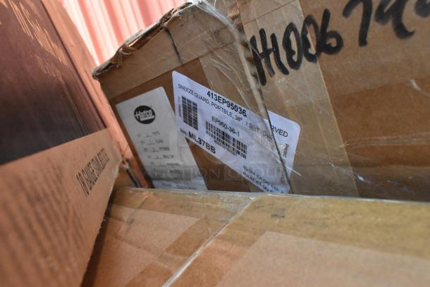 Cardboard boxes containing items with a visible label for a Hatco sneeze guard, model 413EP95036, showing slight wear.