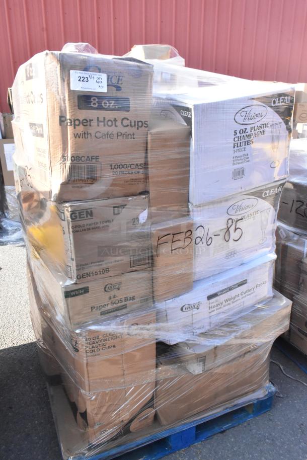 Pallet of scratch and dent items, including paper hot cups, champagne flutes, cutlery, and bags. Labeled "FEB26-85."
