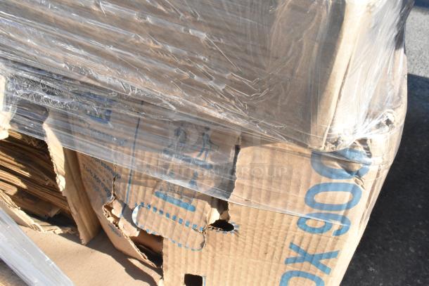 Cardboard box with visible dents and tears, wrapped in plastic, containing mixed new scratch and dent items like pouches and containers.