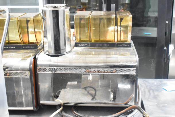 Thermoplan Mastrena Commercial Espresso Machine, 250 Volts, features bean hoppers and labeled controls for various espresso types.